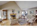 Inviting living room with fireplace, hardwood floors, and natural light at 8400 Middle Fork Rd, Boulder, CO 80302