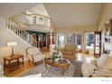 Spacious living room featuring high ceilings, hardwood floors, and a cozy fireplace at 8400 Middle Fork Rd, Boulder, CO 80302