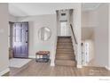 Inviting entryway with hardwood floors, stairs to the upper level, and modern decor at 845 Hartford Dr, Boulder, CO 80305