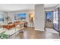 Bright living room featuring a large window, hardwood floors, and stylish furnishings at 845 Hartford Dr, Boulder, CO 80305