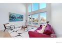 Bright living room boasts soaring ceilings, large windows, and view of private back yard at 10667 E Goose Haven Dr, Lafayette, CO 80026