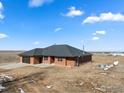 A lovely view of a brick home with an attached garage at 11837 County Road 39, Fort Lupton, CO 80621