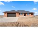 Well-kept brick home boasts an attached two-car garage, a durable roof, and a clean and spacious lot at 11837 County Road 39, Fort Lupton, CO 80621