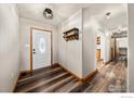 Inviting foyer with hardwood floors, a decorative entry door, and a convenient shelving unit with hooks at 11837 County Road 39, Fort Lupton, CO 80621