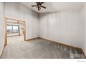 Inviting living room featuring plush carpet, neutral paint, and modern ceiling fan for a comfortable and stylish atmosphere at 11837 County Road 39, Fort Lupton, CO 80621