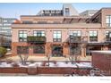 Exterior of a multi-story building featuring balconies and a brick facade in a residential setting at 1360 Walnut St # 204, Boulder, CO 80302