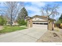 Home exterior with an attached two car garage and concrete driveway at 1460 Harvard St, Longmont, CO 80503