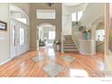 Inviting foyer with hardwood floors, a grand staircase, and elegant decor at 2035 Buchanan Pt, Lafayette, CO 80026