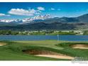 Picturesque golf course view with lake and mountain backdrop, highlighting the scenic location at 2103 Scottsdale Rd, Berthoud, CO 80513