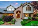 Inviting front entrance with a brick archway and lush landscaping at 2245 Ridgeview Way, Longmont, CO 80504