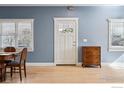 Bright dining room with hardwood floors, a classic door, and large windows providing natural light at 3561 4Th St, Boulder, CO 80304