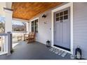 Cozy covered front porch featuring a comfortable chair and side table, ideal for enjoying quiet moments at 3561 4Th St, Boulder, CO 80304
