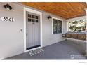 Inviting front porch with wooden ceiling and swing, perfect for relaxing and enjoying the outdoors at 3561 4Th St, Boulder, CO 80304
