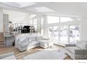 Bright living room with a large sectional, hardwood floors, and doors to a patio at 3590 Longwood Ave, Boulder, CO 80305