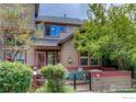 Attractive townhome with a garden, decorative bicycle and mature landscaping at 3648 Oakwood Dr, Longmont, CO 80503