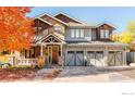 Inviting two-story home with stone, siding, and a three-car garage, surrounded by autumn foliage and a covered porch at 4845 6Th St, Boulder, CO 80304