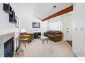 A cozy living room with a fireplace and an exposed beam at 5520 Stonewall Pl # 31, Boulder, CO 80303
