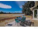 Outdoor patio seating area features a table for six with mountain views and shade at 7034 Indian Peaks Trl, Boulder, CO 80301