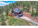 Stunning home with large driveway, solar panels, beautiful landscaping, and wooded surroundings at 795 Pine Brook Rd, Boulder, CO 80304