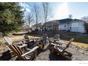 Cozy backyard with a fire pit and Adirondack chairs at 1002 Willow Ct, Longmont, CO 80503