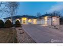 Beautifully lit home with a three car garage and mature landscaping at 1002 Willow Ct, Longmont, CO 80503