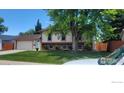Two-story home with garage, inviting front yard, and mature shade tree at 2042 Garfield Ave, Louisville, CO 80027
