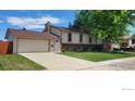 Traditional two-story home boasting a spacious front yard and an attached two-car garage at 2042 Garfield Ave, Louisville, CO 80027
