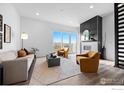 Sunlit living room featuring sleek design, hardwood floors, and a stylish fireplace at 2611 Westview Way, Superior, CO 80027