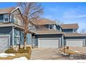 Inviting exterior of a blue two-story home with an attached garage and mature landscaping at 281 Rockview Dr, Superior, CO 80027