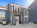 Back exterior of a blue two-story home with a deck, patio, and beautiful arched windows at 281 Rockview Dr, Superior, CO 80027