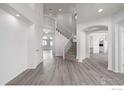 Spacious foyer featuring hardwood floors, a staircase with decorative railings, and arched doorways at 301 Amethyst Way, Superior, CO 80027