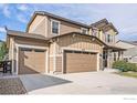 Charming two-story home featuring a three-car garage and a well-manicured lawn at 4679 Lakeside Dr, Longmont, CO 80504
