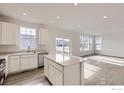 Bright, open kitchen boasts stainless steel appliances and a center island with a breakfast bar at 4846 Astor Pl, Brighton, CO 80601