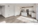 Open concept living space flows into the kitchen featuring light gray floors at 4846 Astor Pl, Brighton, CO 80601
