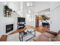 Bright living room with fireplace, hardwood floors, and an open floor plan at 51 21St Ave # 30, Longmont, CO 80501