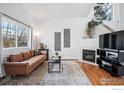 Cozy living room with a brick fireplace, comfortable seating, and ample natural light at 51 21St Ave # 30, Longmont, CO 80501