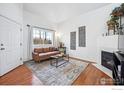 Comfortable living room featuring a fireplace, a large window, and neutral décor at 51 21St Ave # 30, Longmont, CO 80501