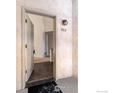 Condo unit 203 entrance, with a white door, showing an open entryway and interior views at 595 Manhattan Dr # 203, Boulder, CO 80303