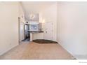 Bright living room with neutral carpet and a glimpse of the kitchen, creating a welcoming space at 595 Manhattan Dr # 203, Boulder, CO 80303