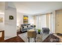 Bright living room with a large sofa, stylish rug, modern furniture, and natural light at 60 S Boulder Cir # 6018, Boulder, CO 80303