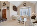 Cozy living room with vaulted ceilings, neutral carpet, and light filled bay window at 630 S Snowmass Cir, Superior, CO 80027