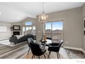 Bright open floor plan, fireplace, vaulted ceiling, and a dining area with access to the deck at 6981 Buckskin Dr, Littleton, CO 80125