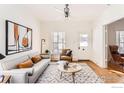 Bright living room with hardwood floors, stylish furniture, and a modern ceiling fan at 921 Maxwell Ave # 18, Boulder, CO 80304