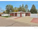A single-Gathering brick home with a driveway, fenced yard, and attached garage at 1211 16Th Ave, Longmont, CO 80501