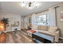 Inviting living room featuring hardwood floors, a large window and comfortable seating at 1211 16Th Ave, Longmont, CO 80501