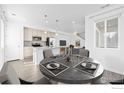 Open concept kitchen with stainless steel appliances and adjacent dining area at 12364 Hayloft Ln, Thornton, CO 80241