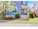 Charming blue home featuring a well-manicured front yard and welcoming entryway at 1526 Haystack Way, Lafayette, CO 80026