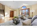 Open-concept living area featuring large windows and comfortable seating at 1749 Foster Dr, Longmont, CO 80501