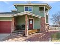 Charming home exterior with a stone facade, covered porch and well-maintained landscaping at 2100 Breckenridge Dr, Berthoud, CO 80513