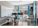 Bright and spacious home office with large window and modern decor at 244 Pipit Lake Way, Erie, CO 80516